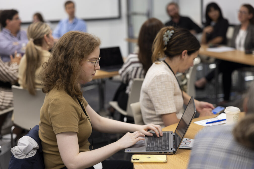 HILT Conference participant typing notes on their laptop