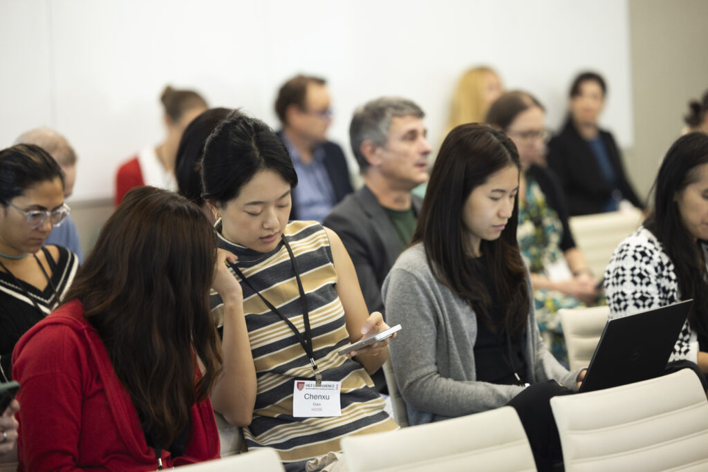 HILT Conference participants looking at a phone and laptop